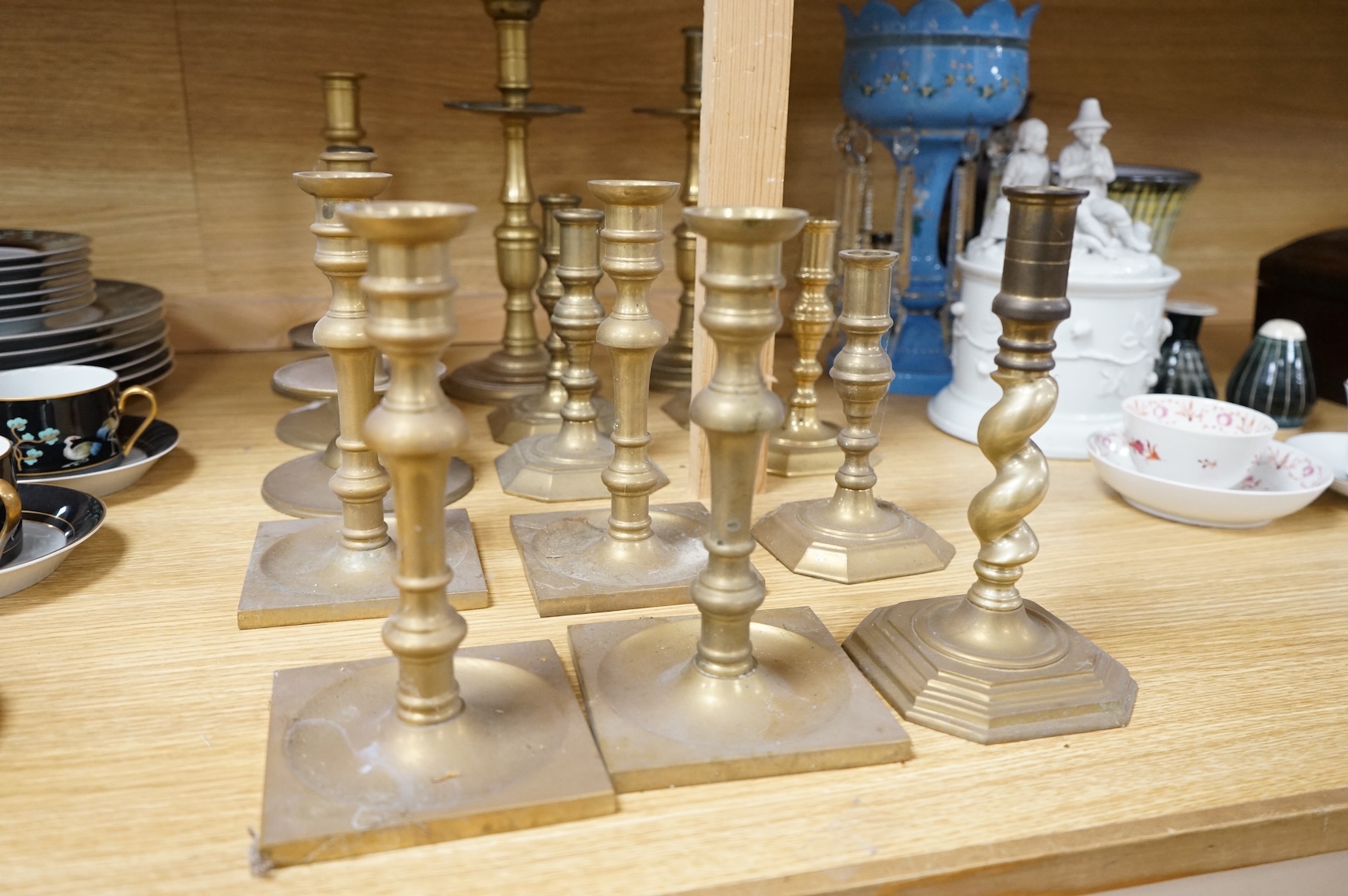 A collection of 19th century and later brass candlesticks, largest 33cm high